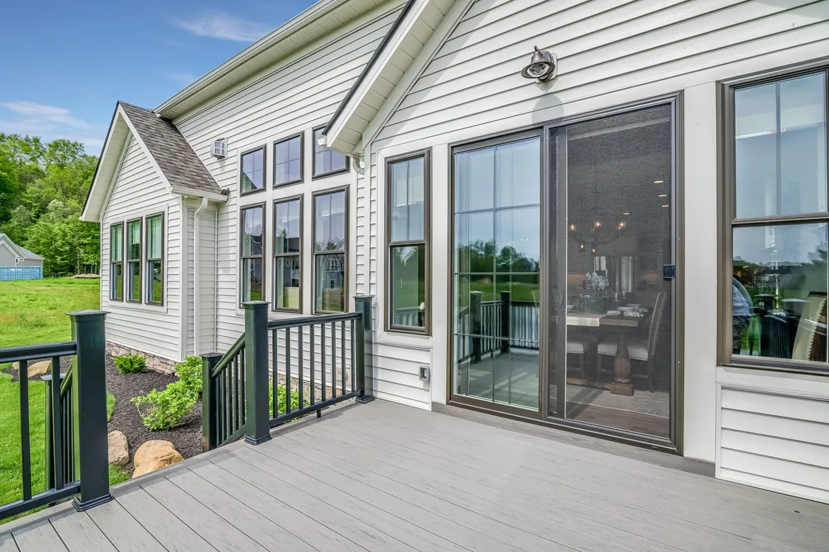 Sliding glass patio door and windows opening onto a composite deck