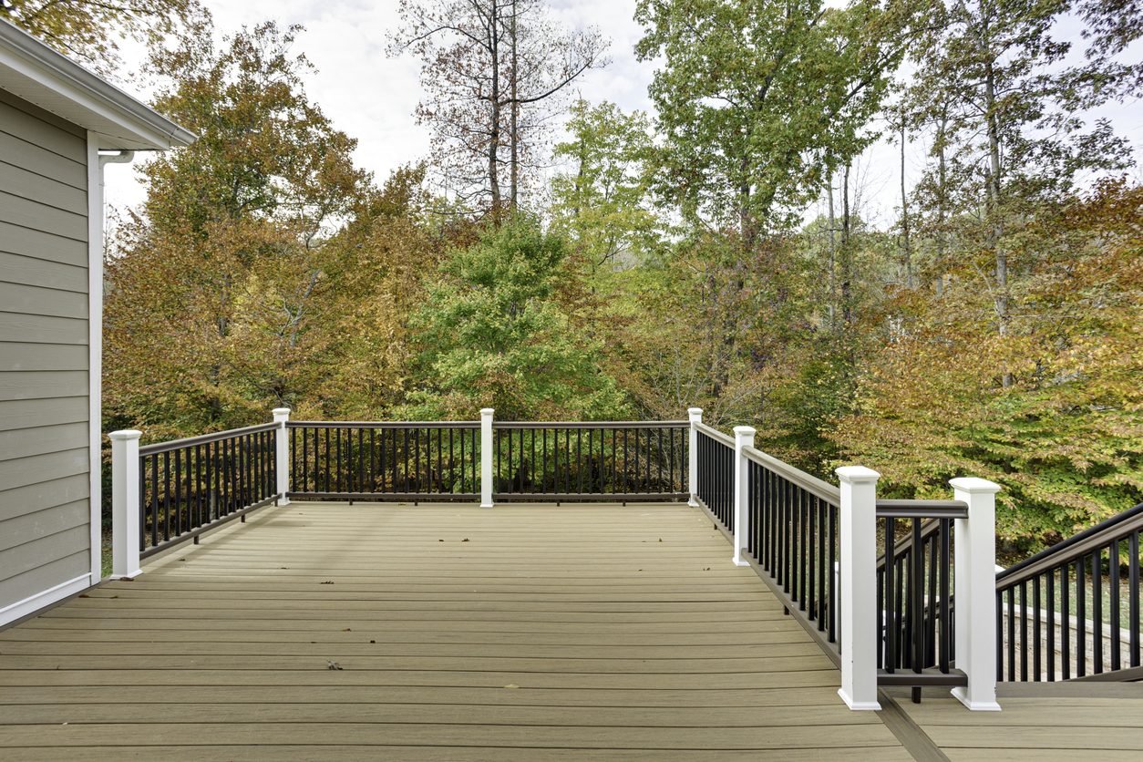 Multi-level composite deck with black aluminum railing and a sturdy staircase