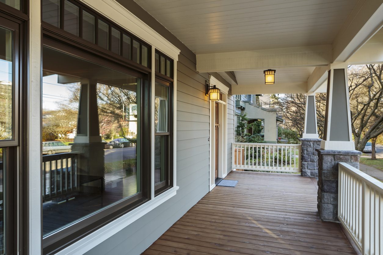 Craftsman home porch with a large picture window and double-hung windows