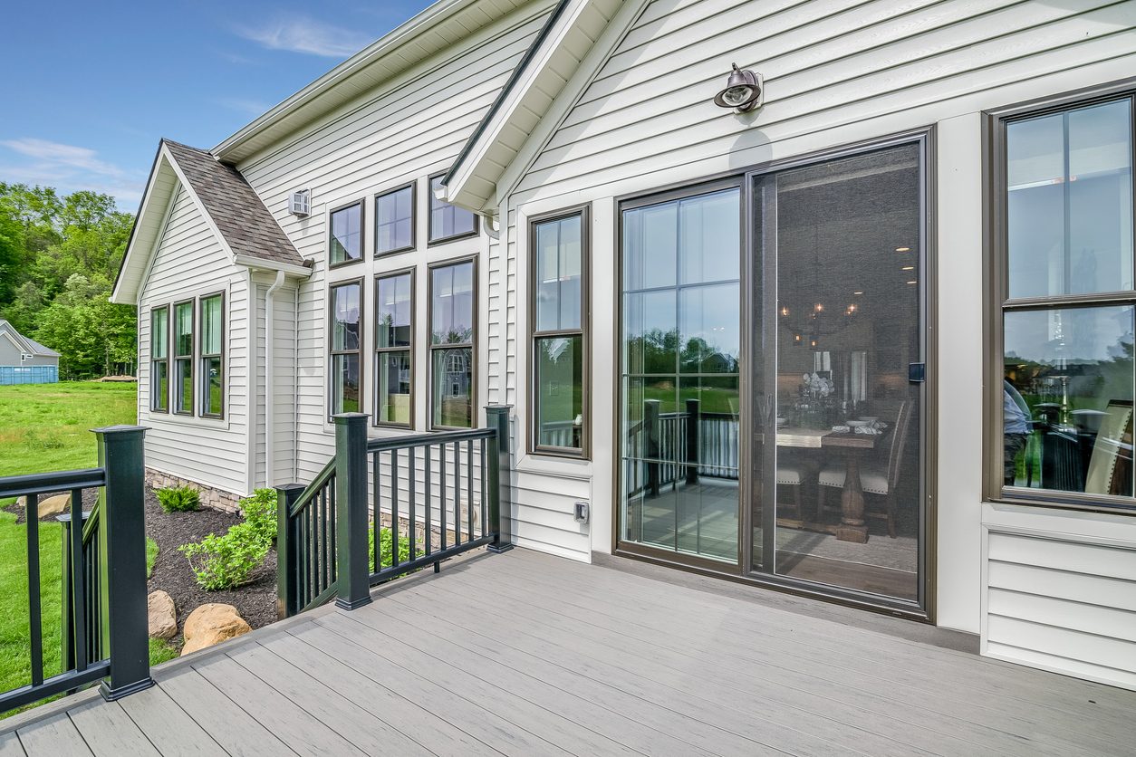 Sliding glass patio door and windows opening onto a composite deck